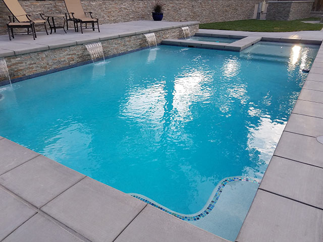 Beautiful Atascadero swimming pool with in pool spa and multiple scuppers.