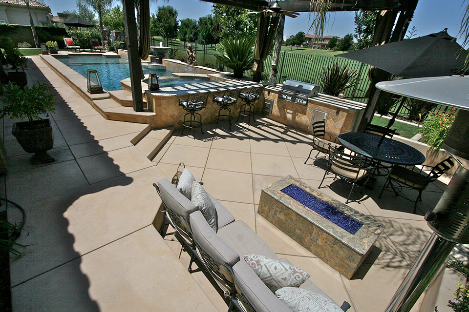 A wonderful outdoor living space featuring a bar, grill, pool, spa, fire pit and outdoor seating. On the golf course in Bakersfield.