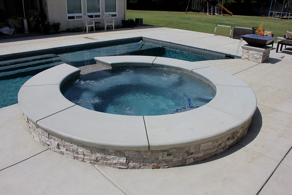 Circular custom spa with pool & fire bowl in Bakersfield, California.